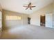 Spacious bedroom with vaulted ceiling, fan, and neutral carpet flooring at 9124 Topneck St, New Port Richey, FL 34654