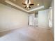 Spacious bedroom features neutral walls, carpeted flooring, recessed lighting, and a tray ceiling at 9124 Topneck St, New Port Richey, FL 34654