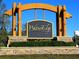 WatersEdge community sign with stone base and lush landscaping on a sunny day at 9124 Topneck St, New Port Richey, FL 34654