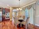 Cozy dining area with a chandelier, table and chairs next to updated stainless steel appliances at 9124 Topneck St, New Port Richey, FL 34654