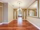 Elegant dining room with hardwood floors, decorative lighting, and arched entryways at 9124 Topneck St, New Port Richey, FL 34654