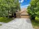Beautiful exterior view of a home featuring a spacious driveway and well-maintained landscaping at 9124 Topneck St, New Port Richey, FL 34654