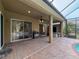 Exterior view of screened in pool area adjacent to the covered patio at 9124 Topneck St, New Port Richey, FL 34654