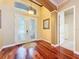 Inviting foyer with gleaming hardwood floors and decorative glass double doors at 9124 Topneck St, New Port Richey, FL 34654