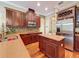 Kitchen featuring an island, stainless steel appliances, and dark wood cabinetry at 9124 Topneck St, New Port Richey, FL 34654
