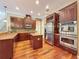 Gourmet kitchen with custom wood cabinets, stainless appliances, and center island at 9124 Topneck St, New Port Richey, FL 34654