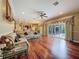 Spacious living room features hardwood floors, elegant furnishings, and sliding glass doors to the outdoor area at 9124 Topneck St, New Port Richey, FL 34654