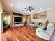 Cozy living room featuring beautiful hardwood flooring and decorative wall accents at 9124 Topneck St, New Port Richey, FL 34654