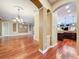 An open-concept living room shows elegant archways and beautiful hardwood flooring at 9124 Topneck St, New Port Richey, FL 34654