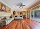 Open living room and kitchen area with hardwood floors and slider access to the outside at 9124 Topneck St, New Port Richey, FL 34654