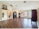 Open-concept living room featuring high ceilings, wood floors, and natural light from multiple windows at 9124 Topneck St, New Port Richey, FL 34654