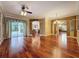 Open living space with hardwood floors, stylish ceiling fan, and seamless access to the backyard at 9124 Topneck St, New Port Richey, FL 34654