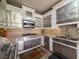 Close-up of outdoor kitchen with stainless appliances and brick-style backsplash at 9124 Topneck St, New Port Richey, FL 34654