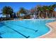 Resort-style swimming pool with lap lanes and a splash zone, providing fun and relaxation at 9124 Topneck St, New Port Richey, FL 34654