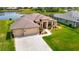 A beautiful backyard view from the air of a private property with lush landscaping and a scenic lake at 9125 Palm Beach Dr, Brooksville, FL 34613