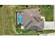 Aerial view of home showing screened in pool, brick pavers, and well manicured landscaping at 9125 Palm Beach Dr, Brooksville, FL 34613