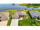 Aerial view of upscale residential community with scenic pond views and lush landscaping and luxurious homes at 9125 Palm Beach Dr, Brooksville, FL 34613