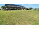 Spacious backyard with a screened-in pool and lush green lawn, perfect for outdoor recreation and relaxation at 9125 Palm Beach Dr, Brooksville, FL 34613