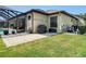 Well-maintained backyard with a brick patio, grill, and lush green lawn, perfect for outdoor gatherings and relaxation at 9125 Palm Beach Dr, Brooksville, FL 34613