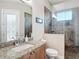 Bathroom featuring granite counters, tile floors, and tiled shower with glass door at 9125 Palm Beach Dr, Brooksville, FL 34613