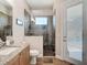 Bathroom featuring a tile shower with glass door and granite counters at 9125 Palm Beach Dr, Brooksville, FL 34613
