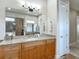 This bathroom features granite counters, wood cabinets, a large mirror and an adjoining shower at 9125 Palm Beach Dr, Brooksville, FL 34613