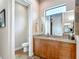 This bathroom features a wood cabinet, a granite counter, and a water closet at 9125 Palm Beach Dr, Brooksville, FL 34613