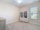 Neutral bedroom with carpet, window, ceiling fan, and built-in bookshelves at 9125 Palm Beach Dr, Brooksville, FL 34613