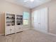 Cozy bedroom with neutral walls, carpet, built in shelving, and double door closet at 9125 Palm Beach Dr, Brooksville, FL 34613
