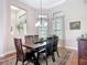 Dining area featuring large windows, chandelier, and pass-through to the kitchen at 9125 Palm Beach Dr, Brooksville, FL 34613