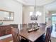 Dining room with statement chandelier, furniture, and view to the living room at 9125 Palm Beach Dr, Brooksville, FL 34613