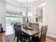 Inviting dining area open to the living room, features a stylish chandelier and ample natural light at 9125 Palm Beach Dr, Brooksville, FL 34613