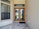 Inviting double door entry with decorative window above, complemented by stylish tile flooring at 9125 Palm Beach Dr, Brooksville, FL 34613