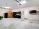 Spacious garage featuring ample storage space, black cabinets, tool organizers and a lawnmower at 9125 Palm Beach Dr, Brooksville, FL 34613