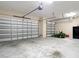 A spacious three car garage features ample storage space with two doors and a lawnmower at 9125 Palm Beach Dr, Brooksville, FL 34613