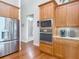 Well-equipped kitchen with stainless steel appliances and wooden cabinetry at 9125 Palm Beach Dr, Brooksville, FL 34613