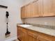 A convenient laundry area features cabinets, granite countertops, a sink and a mounted vacuum at 9125 Palm Beach Dr, Brooksville, FL 34613
