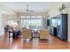 Spacious living room with hardwood floors and a wall of windows overlooking the lake at 9125 Palm Beach Dr, Brooksville, FL 34613