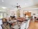 Open-concept living room with hardwood floors, comfortable seating, and access to other living spaces at 9125 Palm Beach Dr, Brooksville, FL 34613