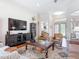 Bright living room featuring hardwood floors, leather chairs, and a decorative area rug at 9125 Palm Beach Dr, Brooksville, FL 34613