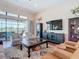 Comfortable living area with stylish furniture, hardwood floors, and expansive views of the pool and lake at 9125 Palm Beach Dr, Brooksville, FL 34613