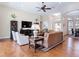 Cozy living room with hardwood floors, plush seating, and lots of natural light at 9125 Palm Beach Dr, Brooksville, FL 34613