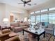 Bright living room with hardwood floors, comfortable seating, and panoramic views of the lake at 9125 Palm Beach Dr, Brooksville, FL 34613