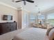 This main bedroom features neutral walls, a ceiling fan, and access to the pool area at 9125 Palm Beach Dr, Brooksville, FL 34613