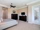 This main bedroom features neutral walls, two dressers, a ceiling fan, and access to the pool area at 9125 Palm Beach Dr, Brooksville, FL 34613