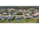 Aerial view of community with mature trees, ponds, and well-maintained single-Gathering homes at 9125 Palm Beach Dr, Brooksville, FL 34613
