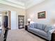 Comfortable home office with a sofa, bookshelf and natural light at 9125 Palm Beach Dr, Brooksville, FL 34613