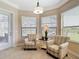 This sitting area features a pair of chairs and a beautiful view of the lanai, pool and beyond at 9125 Palm Beach Dr, Brooksville, FL 34613