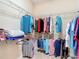 A well-organized walk-in closet with wire shelving and carpeted floors, offering efficient storage solutions at 9125 Palm Beach Dr, Brooksville, FL 34613