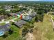 Aerial view of a home located on a golf course with a pond and surrounded by lush landscaping and residential properties at 9216 Tarleton Cir, Weeki Wachee, FL 34613